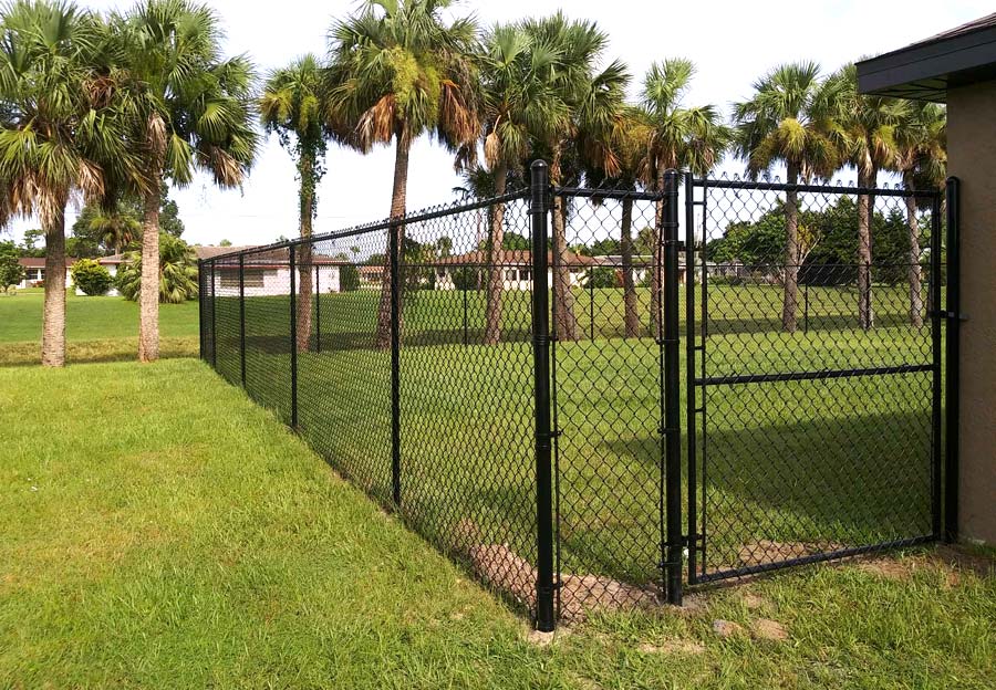 Very tall chain link fence with gate.