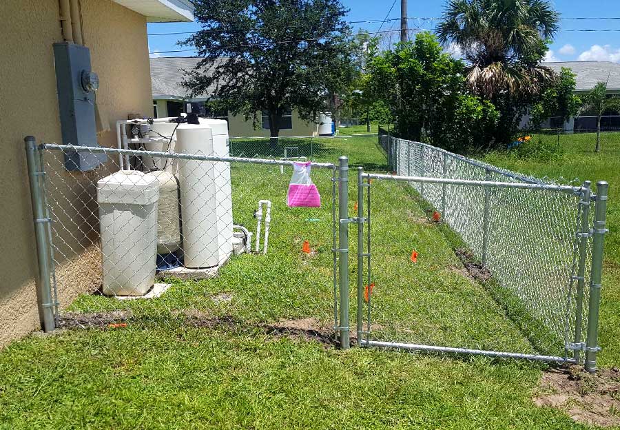 Newly installed a white chain link fence.