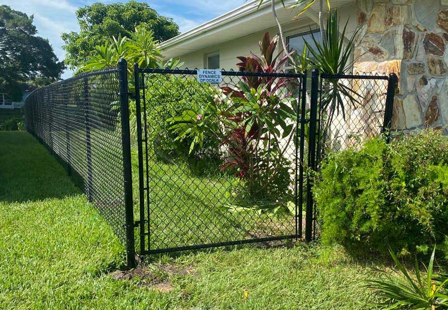 Close-up of a tall black chain link fence.